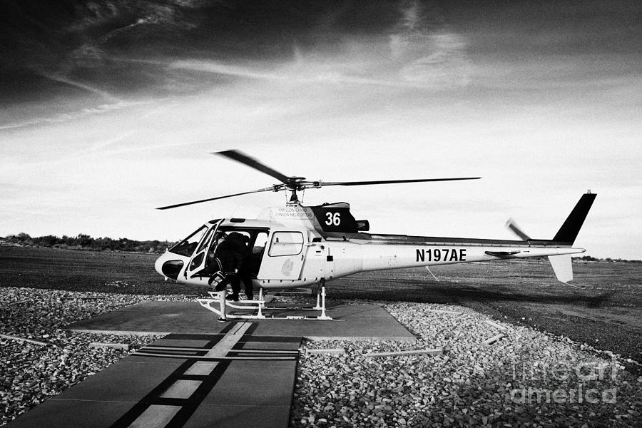 Grand Canyon National Park Photograph - passengers boarding papillon helicopter tours on helipad at Grand canyon west airport Arizona USA #2 by Joe Fox