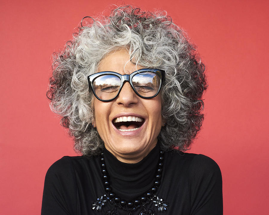 Portrait of mature woman laughing Photograph by Flashpop