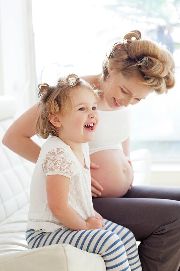 Pregnant Woman And Daughter Smiling Photograph By Ian Hooton Science