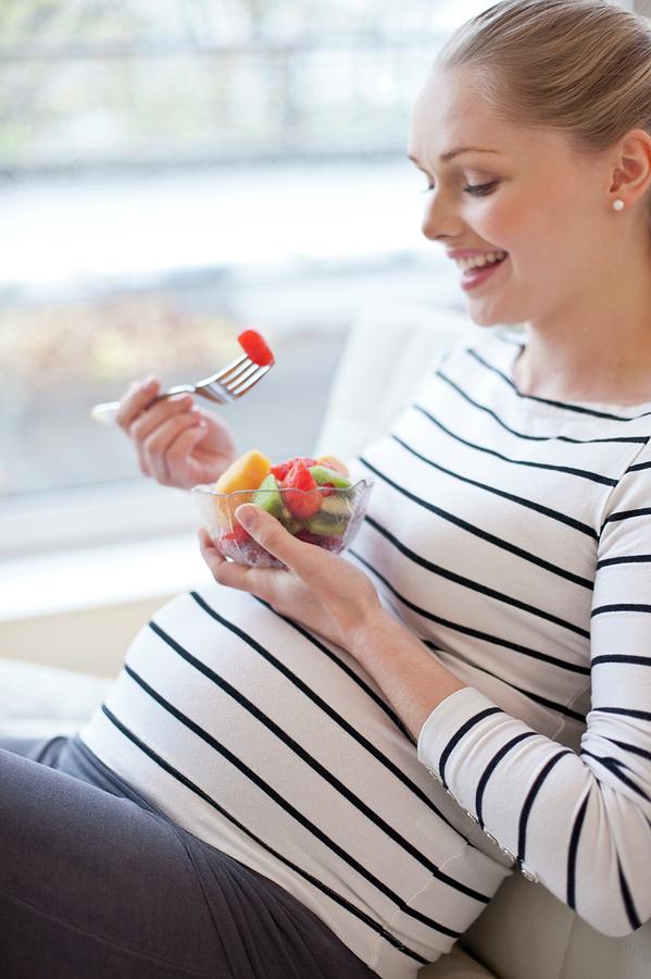 Pregnant Woman Eating Fruit Salad #2 Photograph by Ian Hooton/science Photo Library
