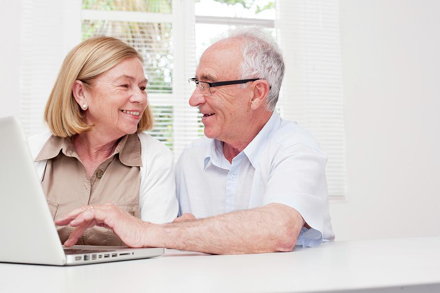 Silver Surfer Photograph - Senior Couple Using Laptop #2 by Science Photo Library
