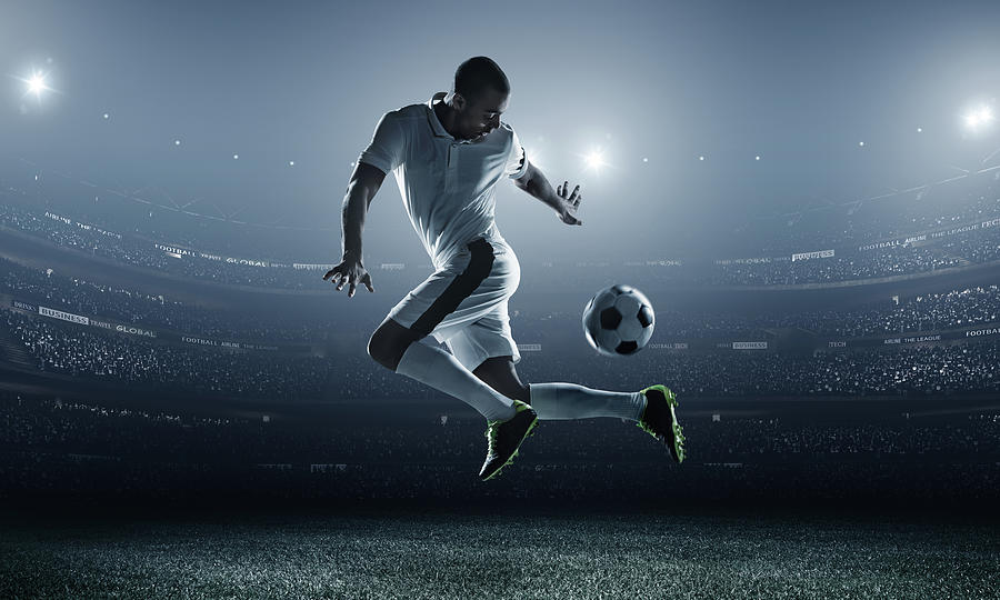Soccer Player Kicking Ball In Stadium by Dmytro Aksonov
