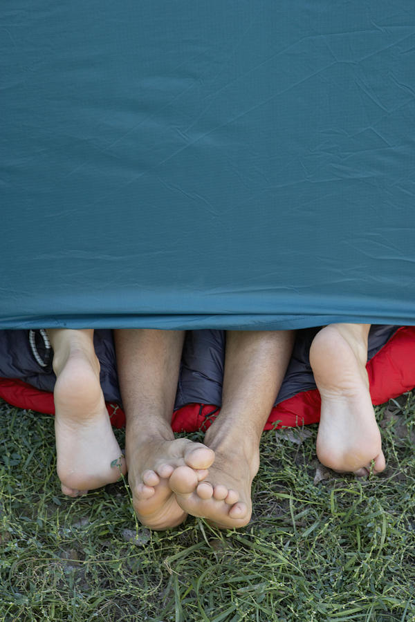 Two peoples feet sticking out of tent door. #2 Photograph by Axel Bernstorff