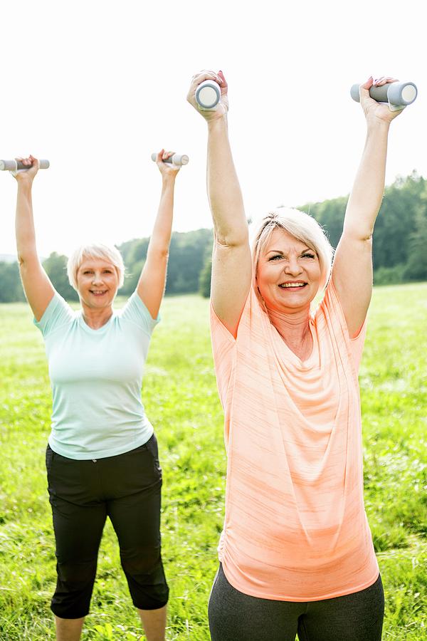 Two Women Exercising With Hand Weights Photograph by Science Photo ...