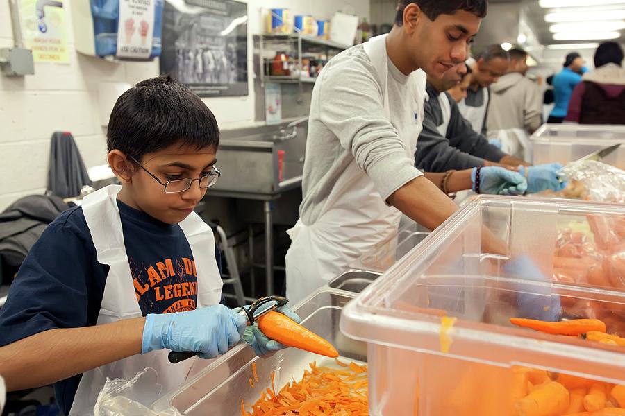 Carrot Photograph - Volunteers At A Community Kitchen #2 by Jim West