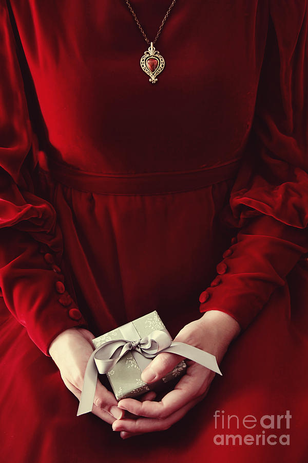 Woman in red dress holding small gift #2 Photograph by Sandra Cunningham
