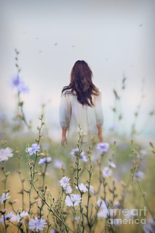 Woman walking in field of blue flowers #2 Photograph by Sandra Cunningham
