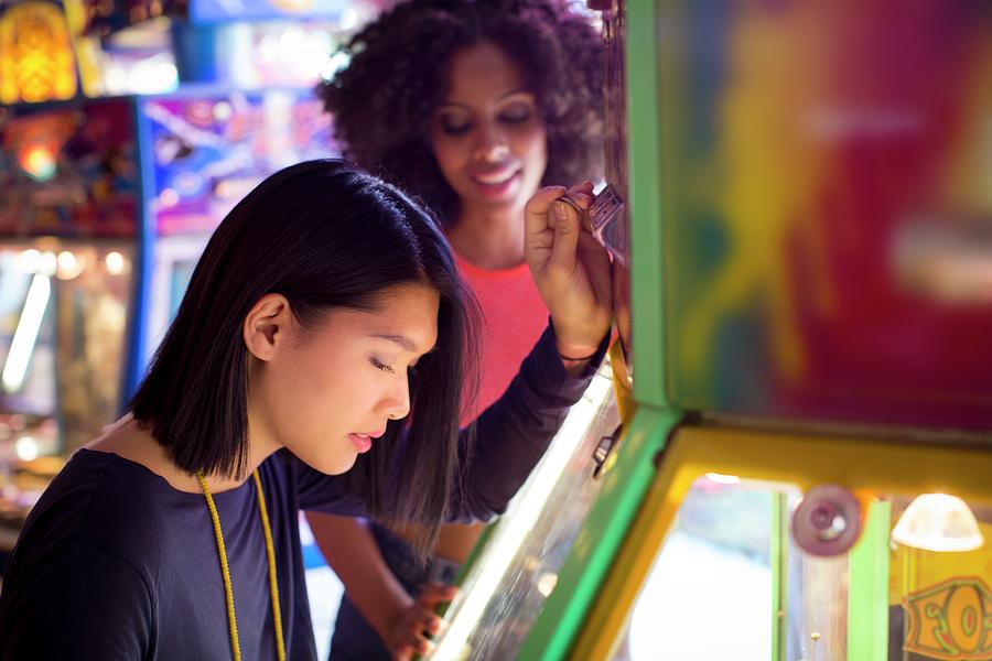 Women Playing Arcade Game At Fun Fair Photograph by Science Photo