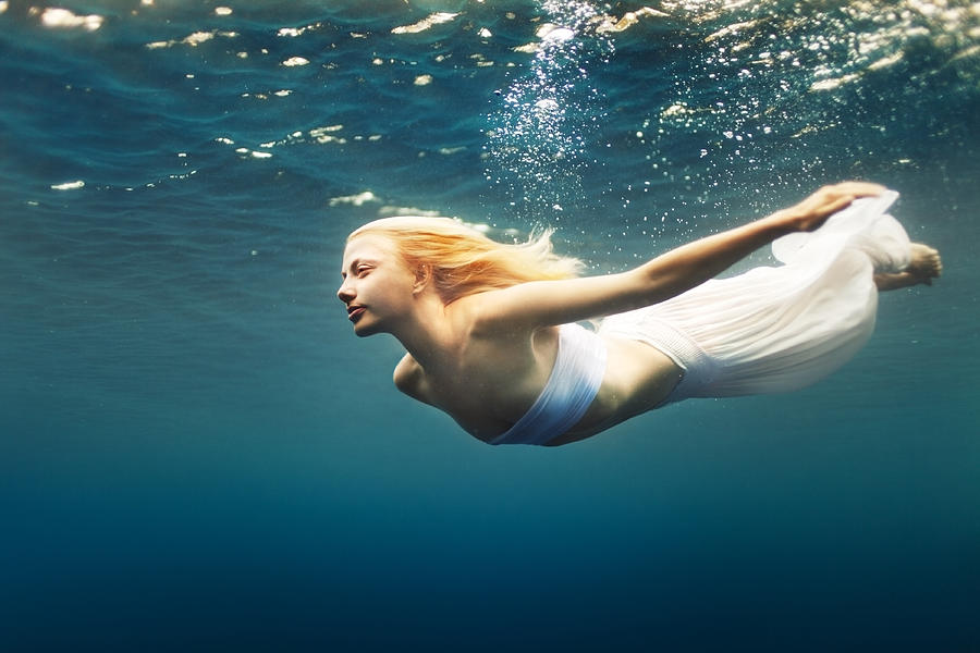 Young woman dive into deep water Photograph by Piskunov