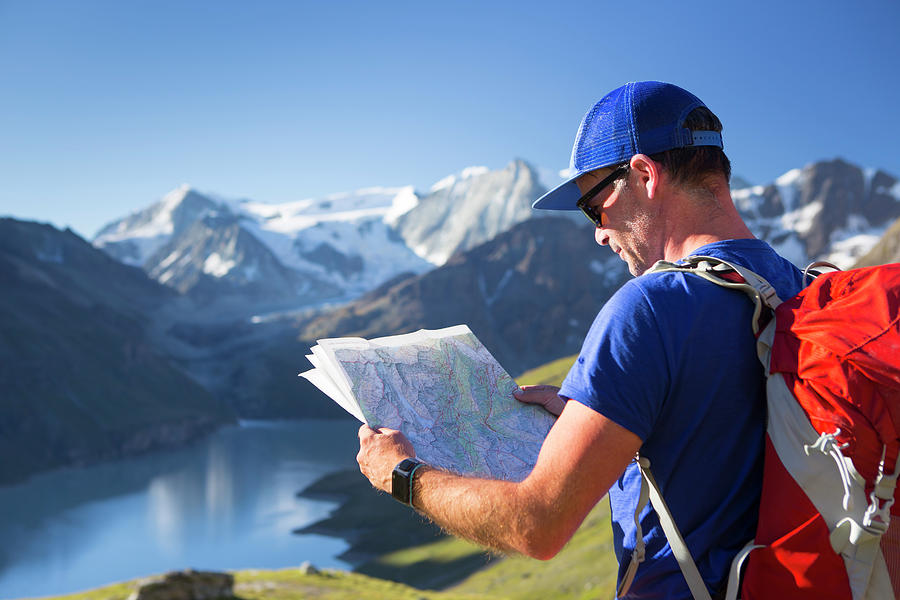 A Male Hiker Is Looking At A Map Photograph by Menno Boermans | Fine ...