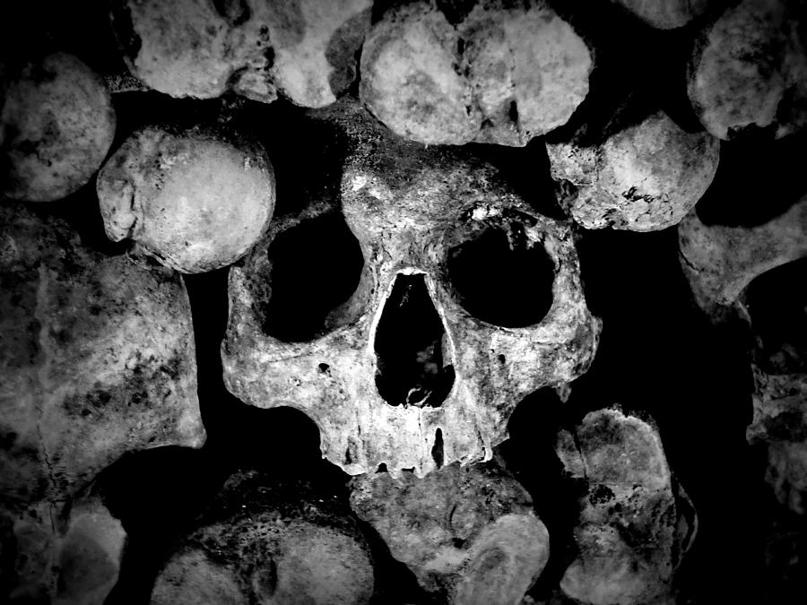 Altered Image Of Skulls And Bones In The Catacombs Of Paris France Photograph