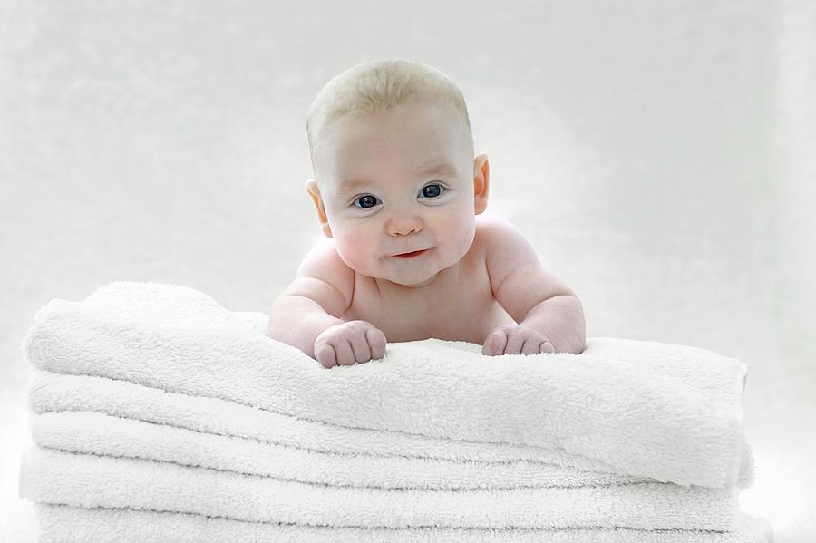 Baby Boy Lying On Towels Photograph by Ruth Jenkinson