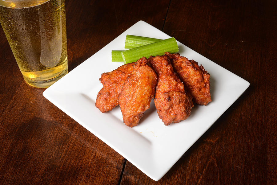 Buffalo Wings With Celery Sticks And Beer Photograph