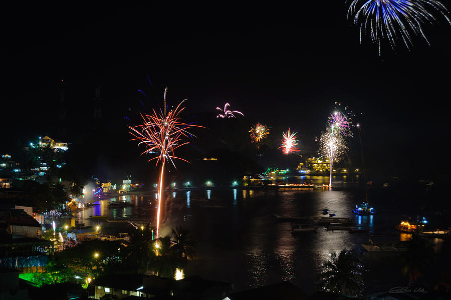 Fireworks Display Over A Tropical Village Photograph by Colin Utz