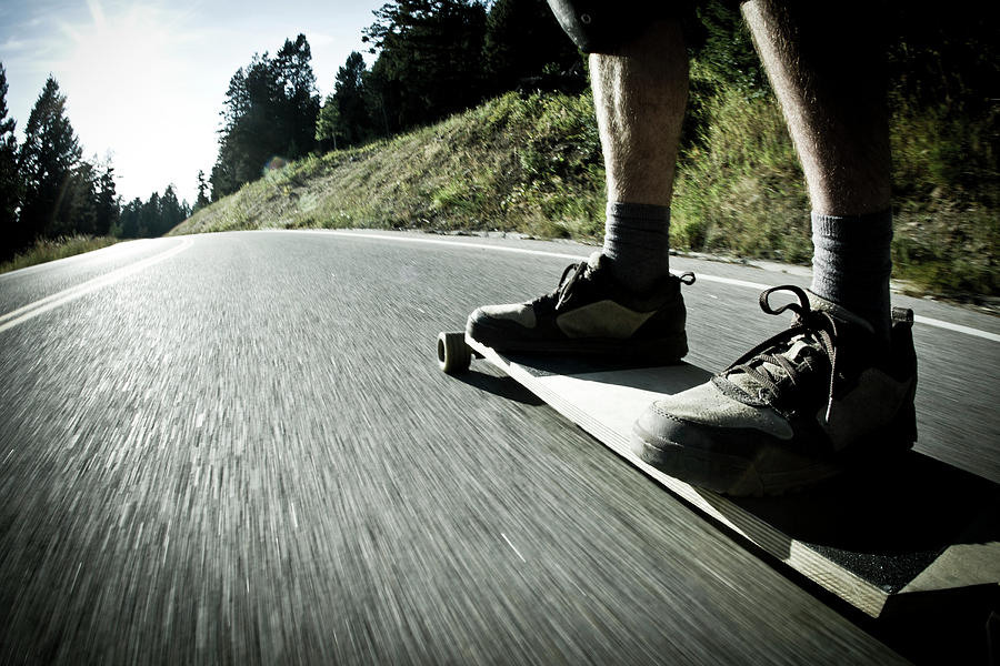 Landscape Photograph - Male Rides Long Board Down Paved Road #3 by Gabe Rogel