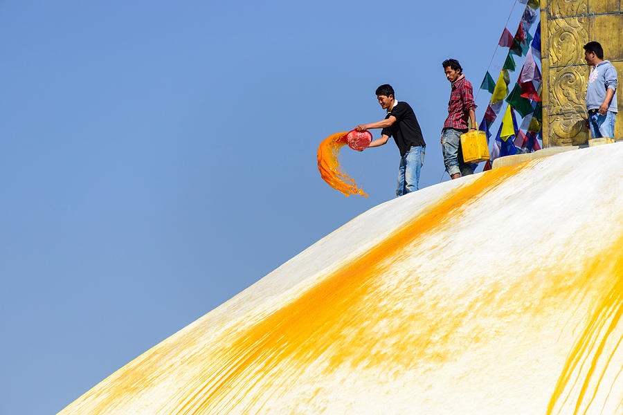 Man throwing orange paint on Boudhanath stupa #3 Photograph by Dutourdumonde Photography