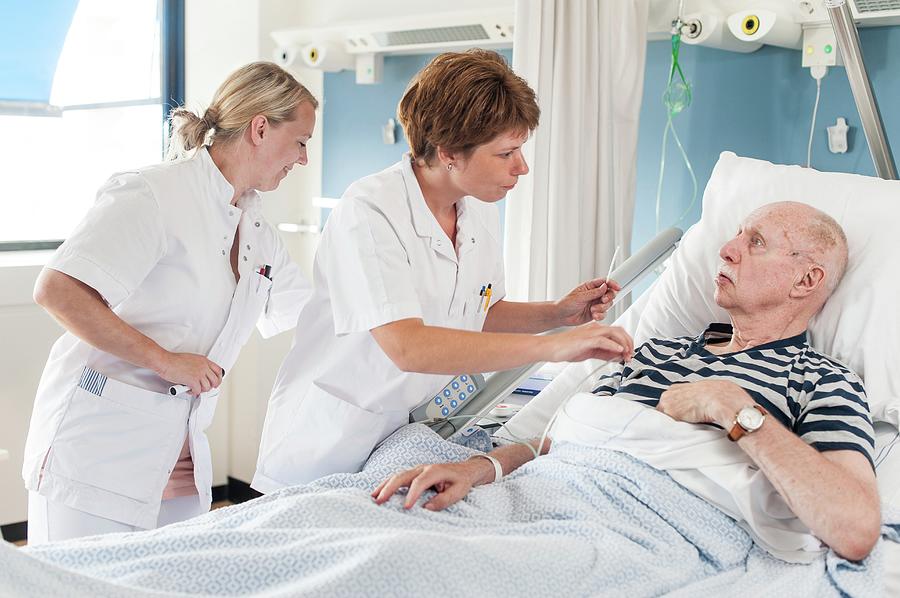 Patient With Nurses #3 by Arno Massee/science Photo Library