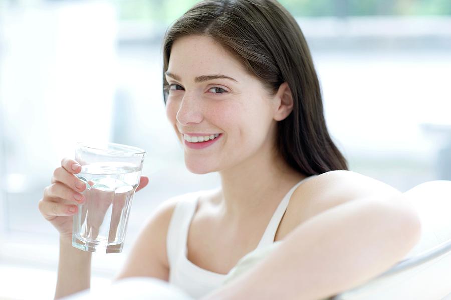 Woman Drinking A Glass Of Water Photograph By Ian Hooton Science Photo