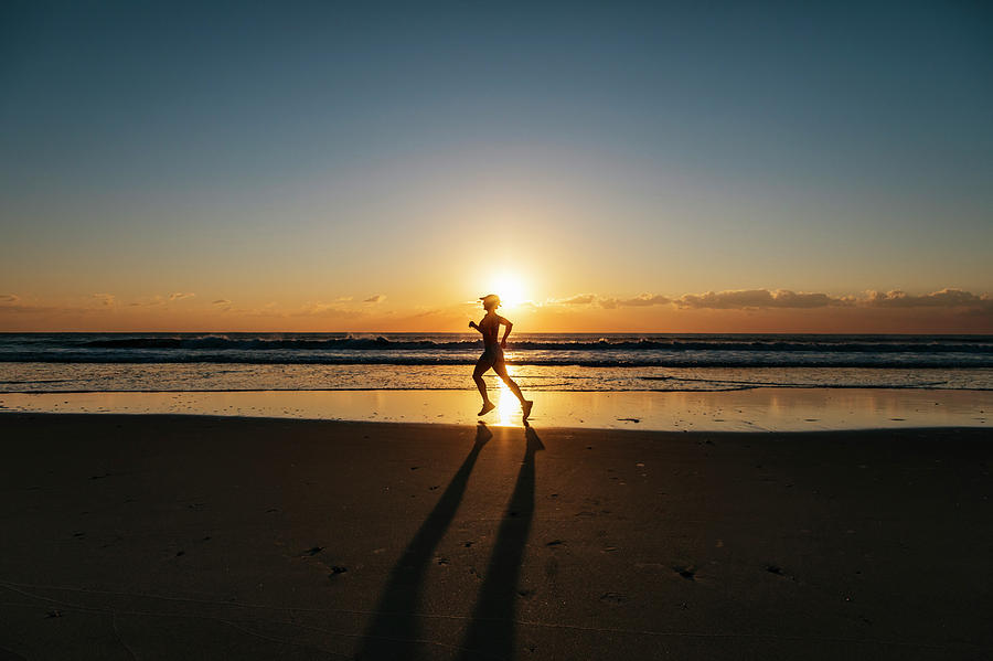 Woman Jogging On Beach At Sunrise Photograph by Andrew Peacock - Pixels