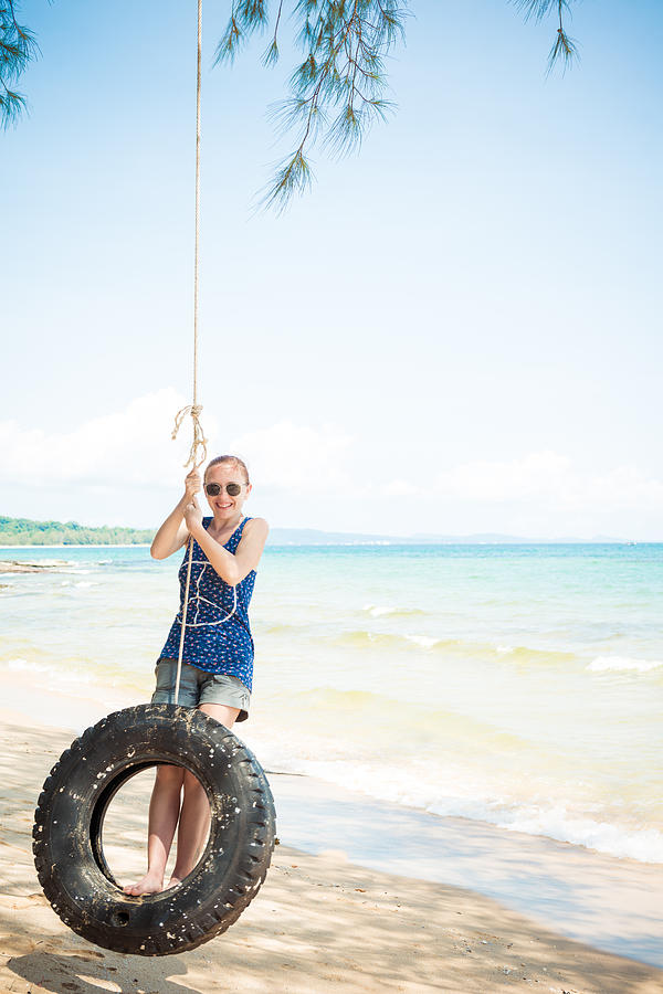 Happy Woman On Tire Swing Photograph