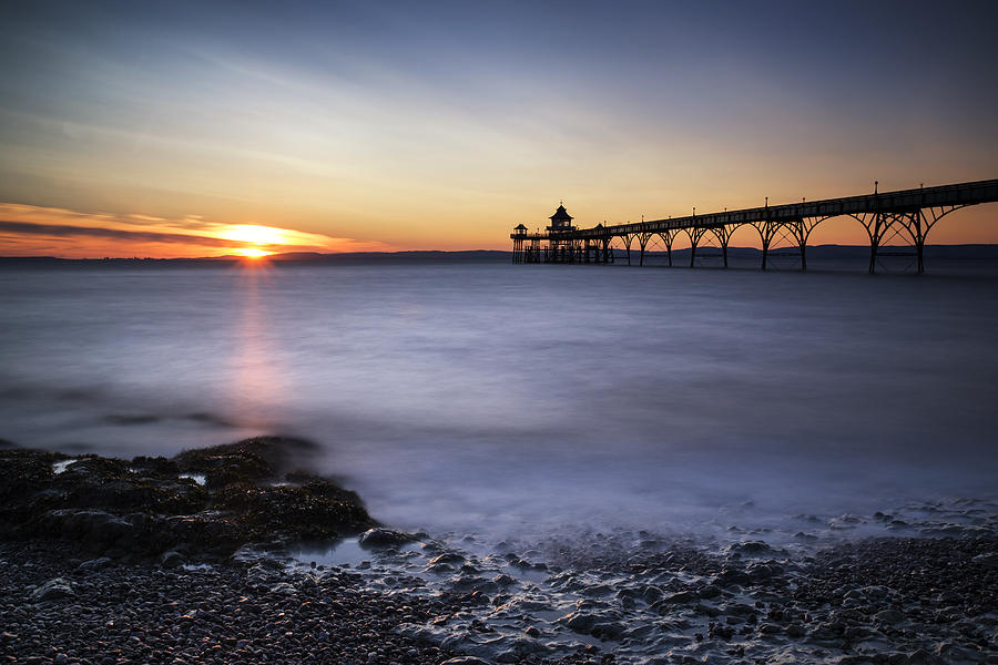 Stunning landscape image of old pier silhouette against vibrant ...