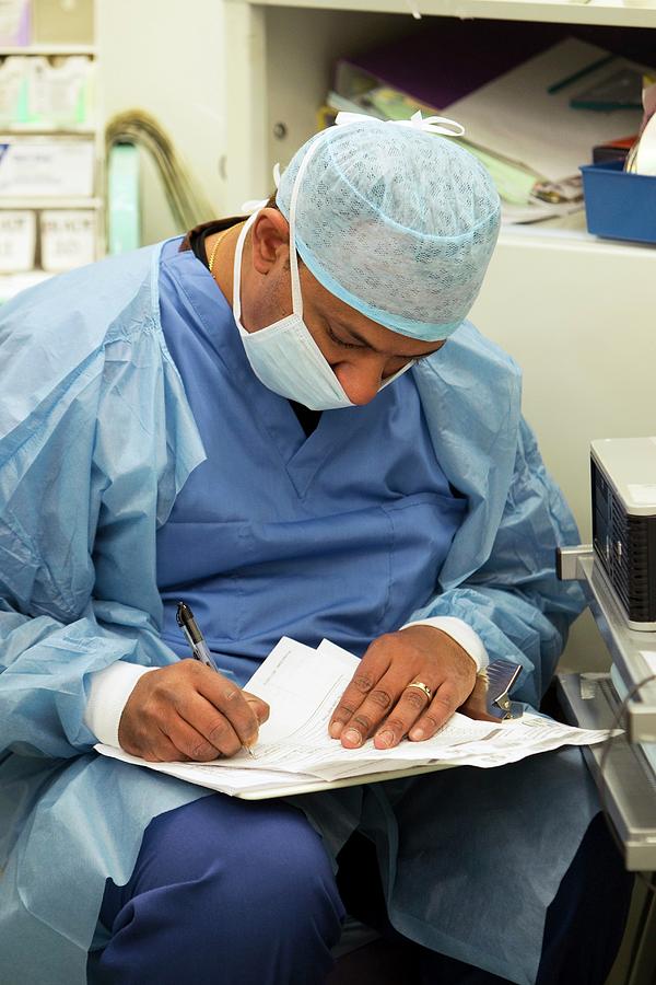 Surgeon Writing Notes #4 Photograph by Mark Thomas/science Photo Library