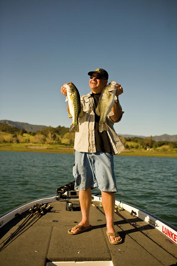 Fish Photograph - A Man Holds Up His Catch Proudly #5 by Jay Reilly