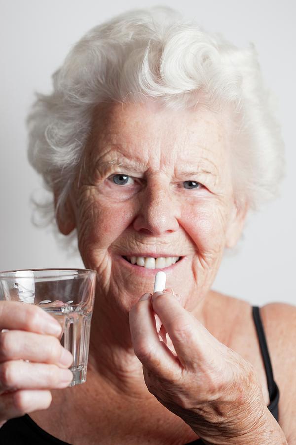 Elderly Woman Taking A Pill Photograph By Cristina Pedrazzini Science Photo Library