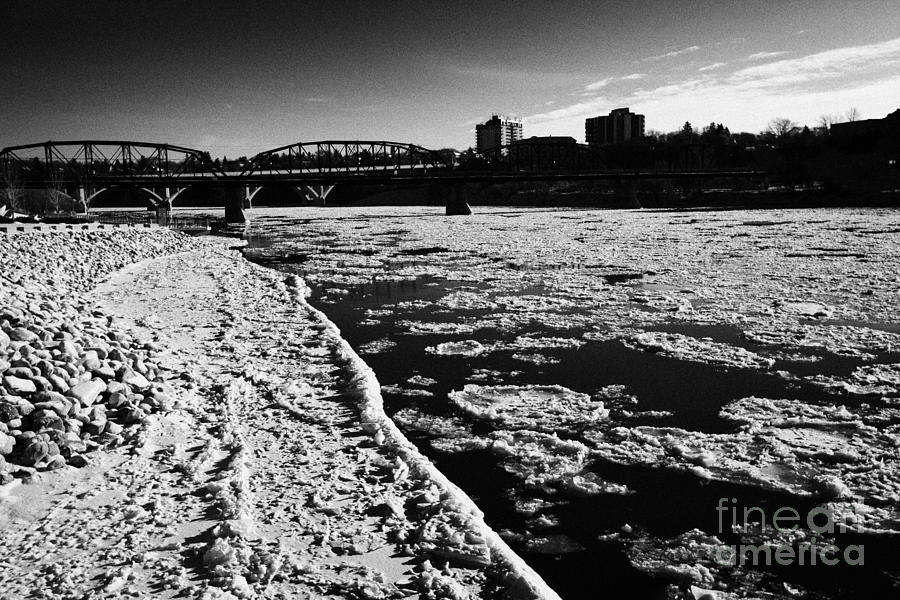 Winter Photograph - large chunks of floating ice on the south saskatchewan river in winter flowing through downtown Sask #5 by Joe Fox