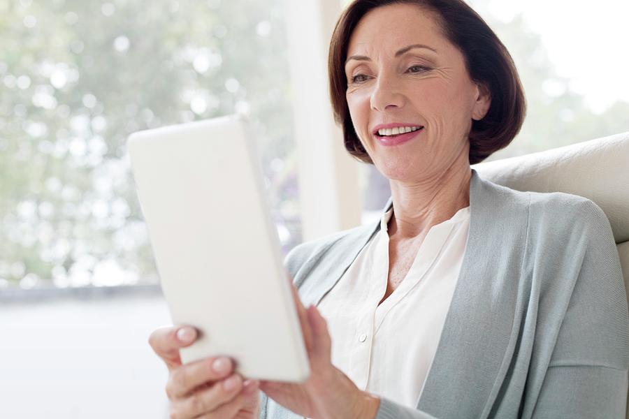 Mature Woman Using Digital Tablet Photograph By Science Photo Library