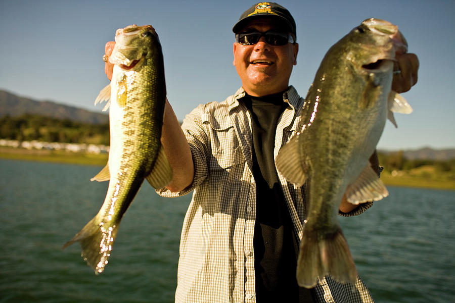 Fish Photograph - A Man Holds Up His Catch Proudly #6 by Jay Reilly