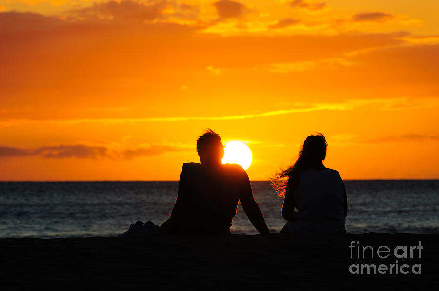 Couple watching the sunset on a beach in Maui Hawaii USA #6 Photograph by Don Landwehrle