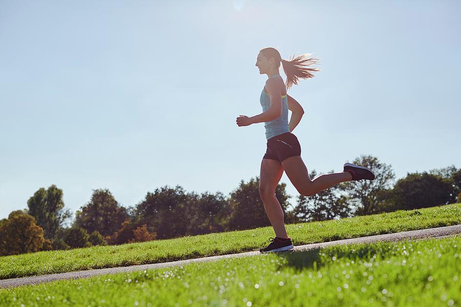 Young Woman Jogging On A Path Photograph By Science Photo Library - Pixels