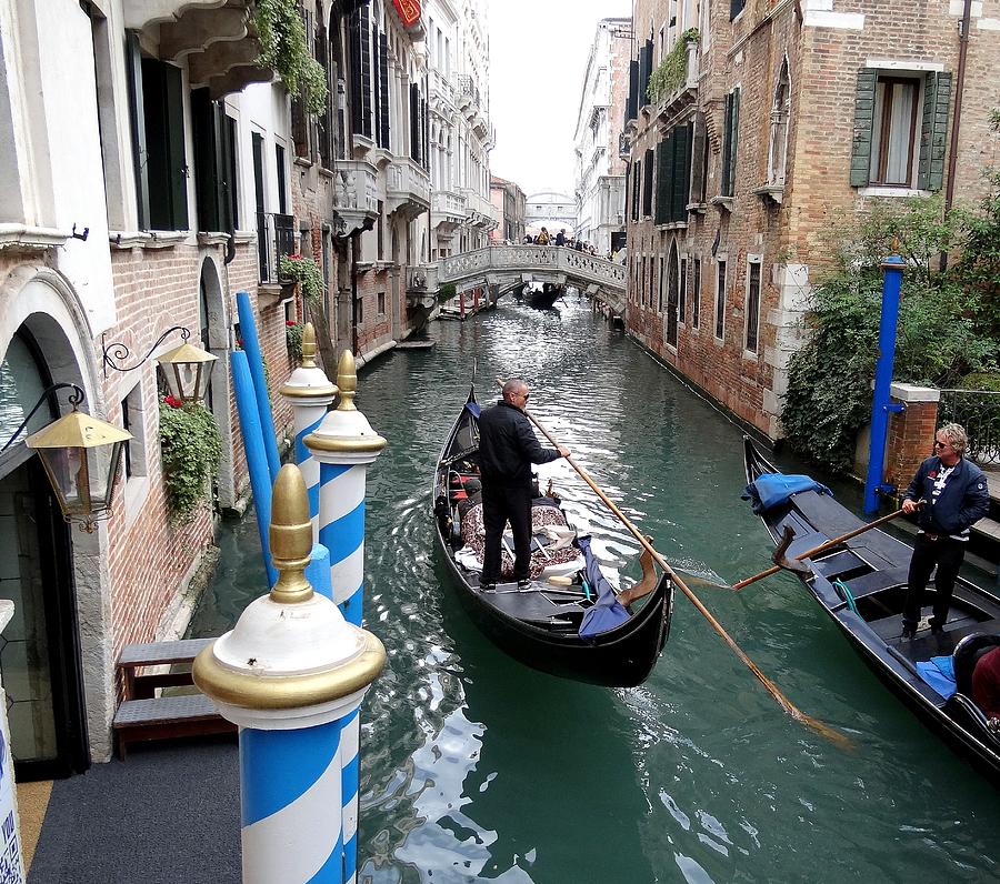 Skillfully Navigating The Canals Of Venice Photograph by Rick Rosenshein