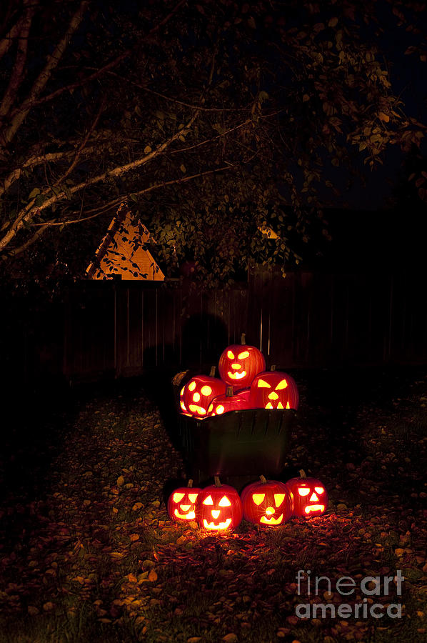 Lit Carved Pumpkins In A Wheel Barrow Photograph by Jim Corwin