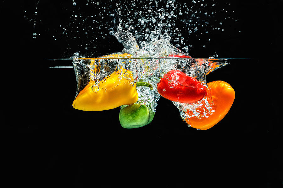 Splashing Paprika Photograph by Peter Lakomy