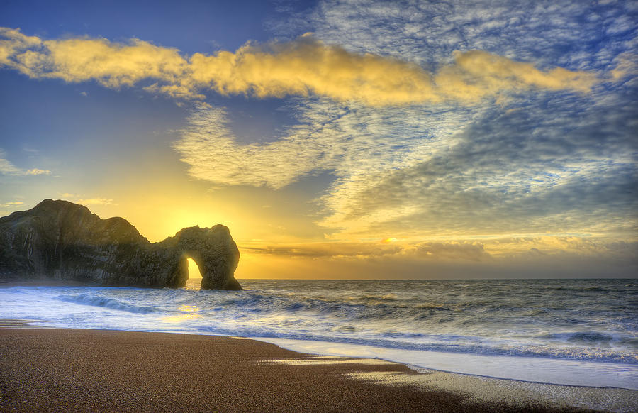 Vibrant sunrise over ocean with rock stack in foreground Photograph by ...