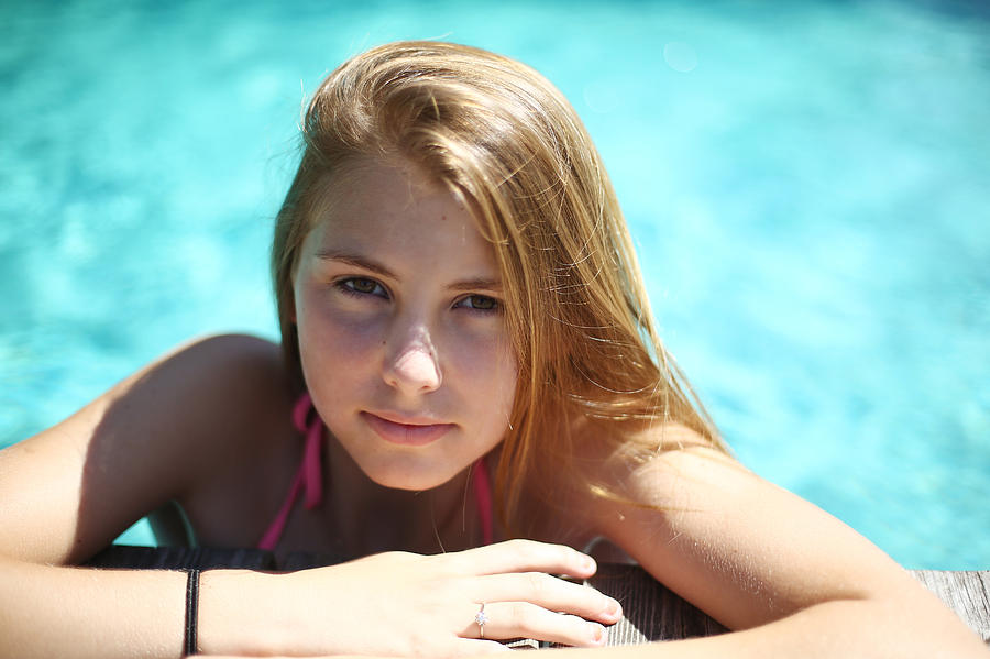 A 14 years old girl in a pool Photograph by Catherine Delahaye