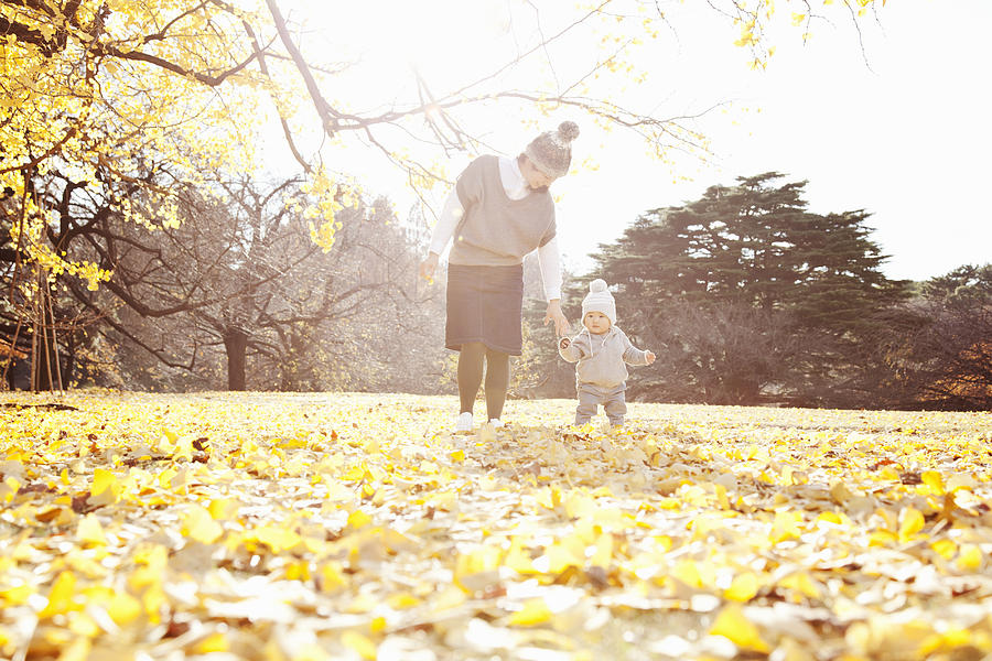 A Baby And Mother Playing In The Park In Autumn Photograph by Kohei Hara