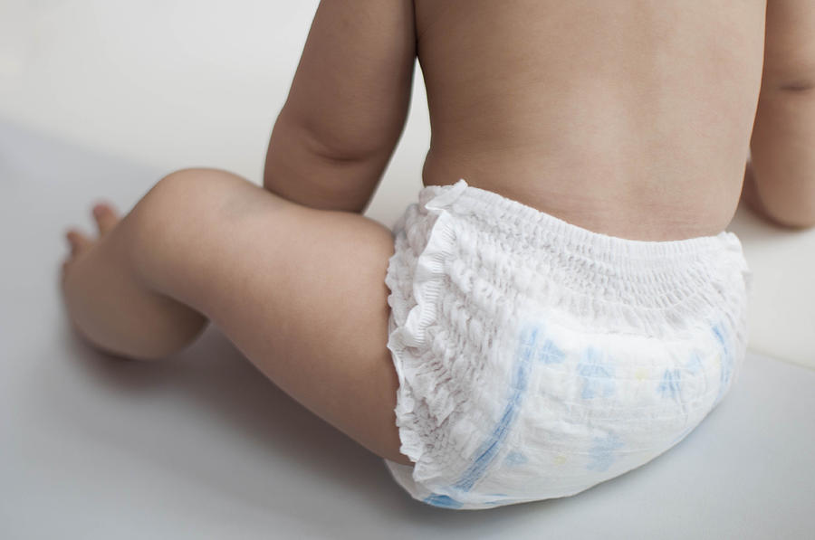 A baby boy is wearing a diaper only Photograph by Karl Tapales