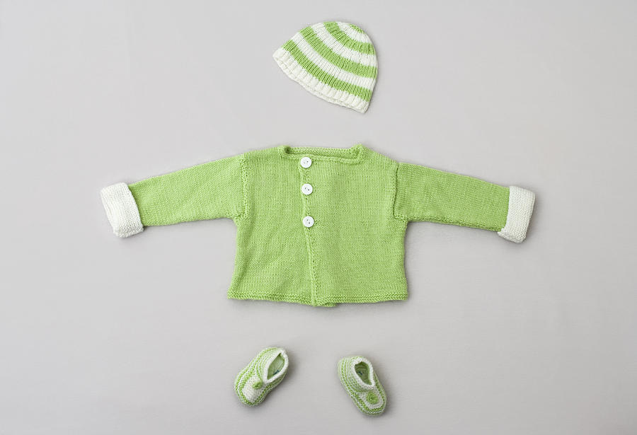 A baby sweater, knit hat and baby booties Photograph by Ragnar Schmuck