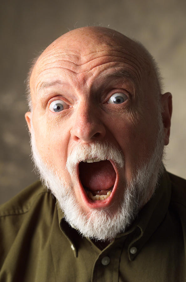 A Bald Elderly Caucasian Man With A White Beard Is Wearing A Dark Dress Shirt And Screaming Wide Eyed Photograph by Photodisc