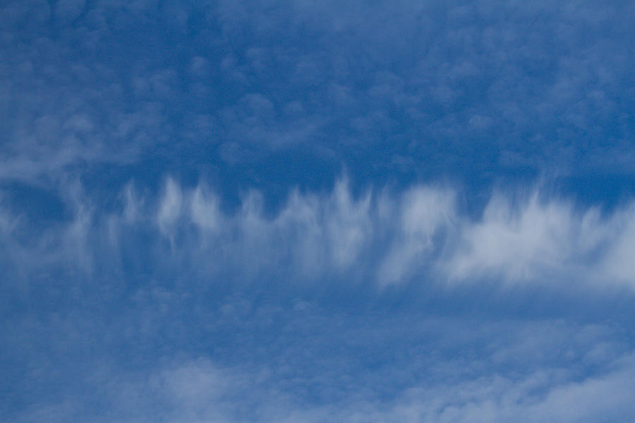 A batch of interesting clouds in a blue sky Photograph by Eti Reid