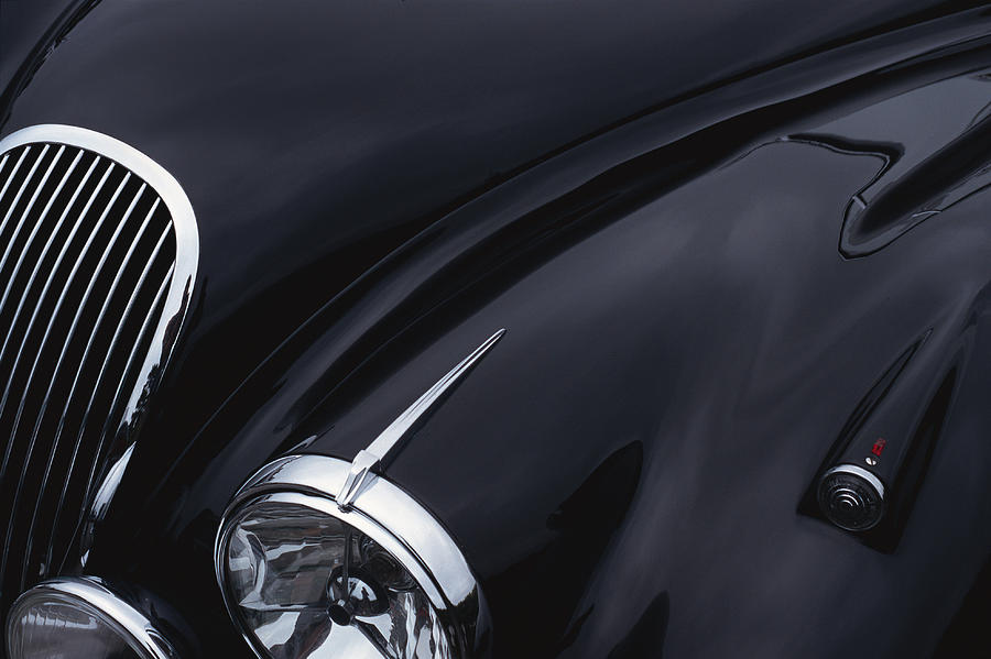 A Black Jaguar Sports Car Hood Showing A Grill And Headlight Photograph by Photodisc