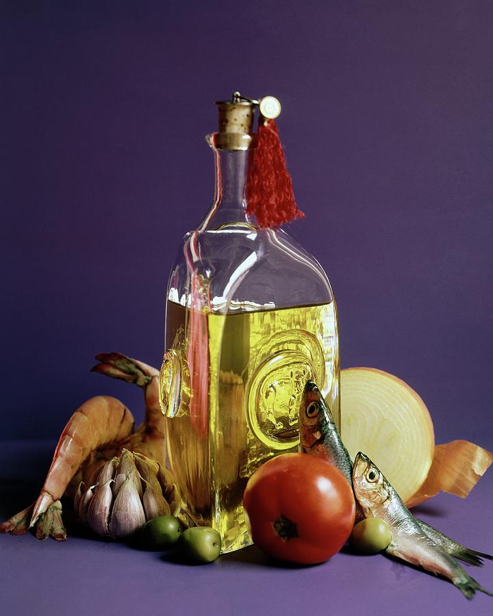 A Bottle Of Olive Oil Surrounded By A Variety Photograph by Fotiades