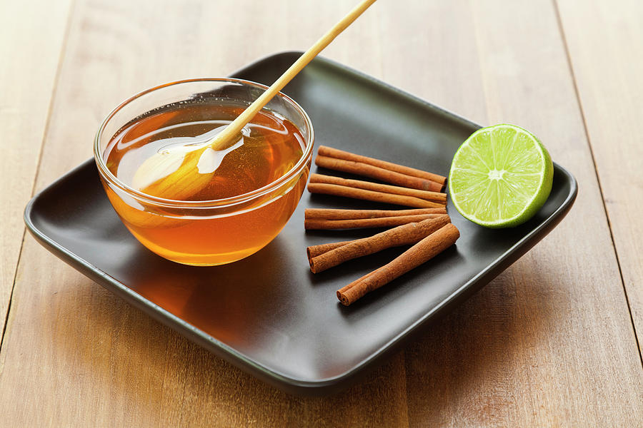 A Bowl Of Honey, Lime And Cinnamon Photograph by Juan Silva