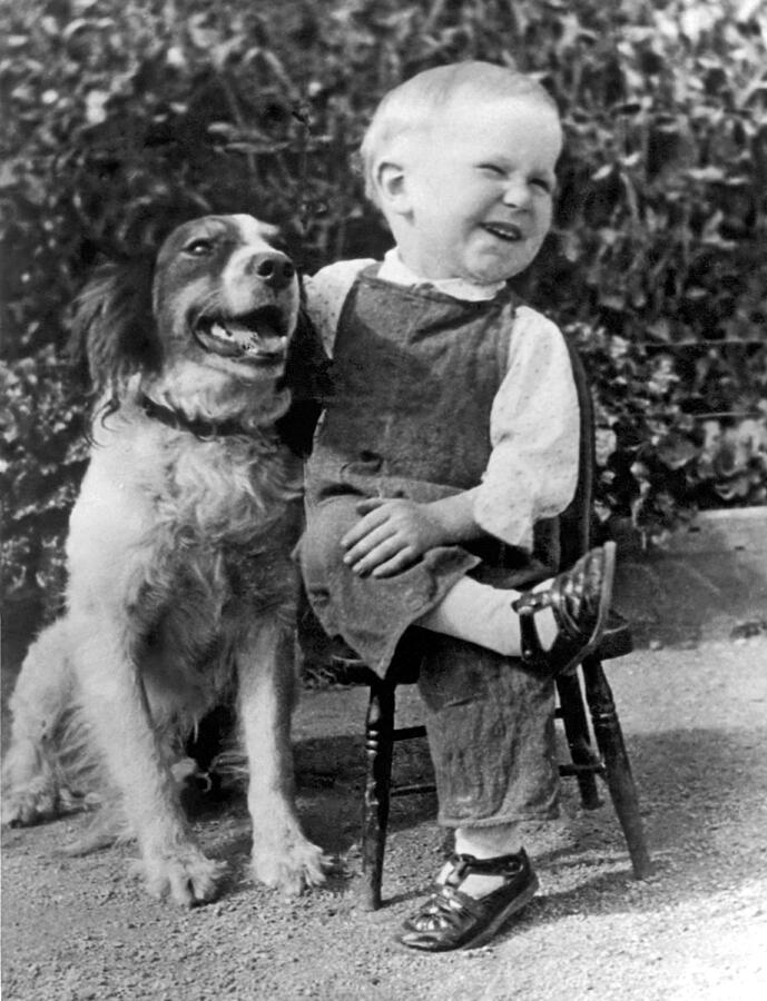 Animal Photograph - A Boy Laughs With His Dog by Underwood Archives