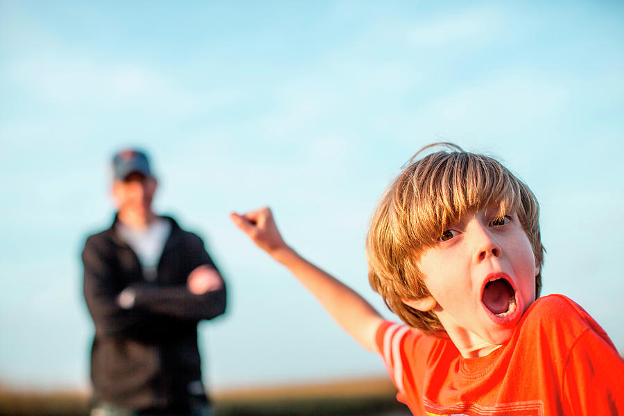 Sunset Photograph - A Boy Yells Outside, While His Father by Logan Mock-Bunting
