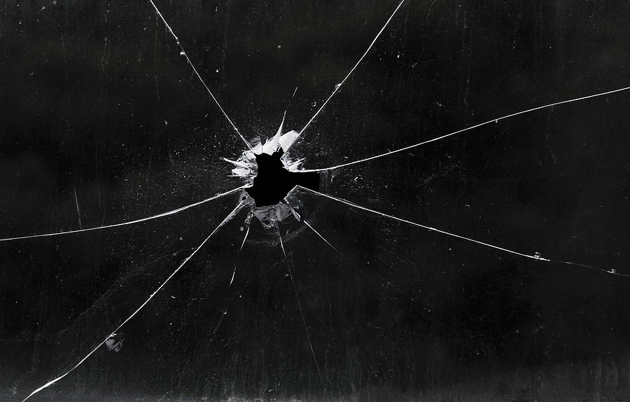 A bullet hole in a glass window Photograph by Fpm