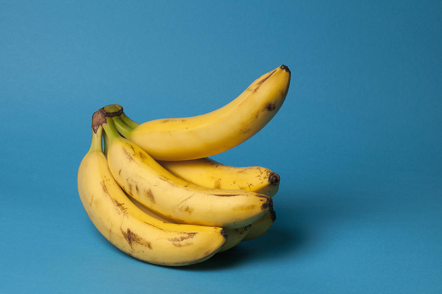 A bunch of bananas with one banana sticking up, suggestive of an erection Photograph by Larry Washburn